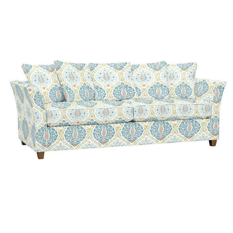 The Tate Queen Sleeper features a floral and geometric patterned design in light blue, teal, orange, and white, complete with square arms, three seat cushions, and several matching throw pillows that showcase the same intricate pattern.